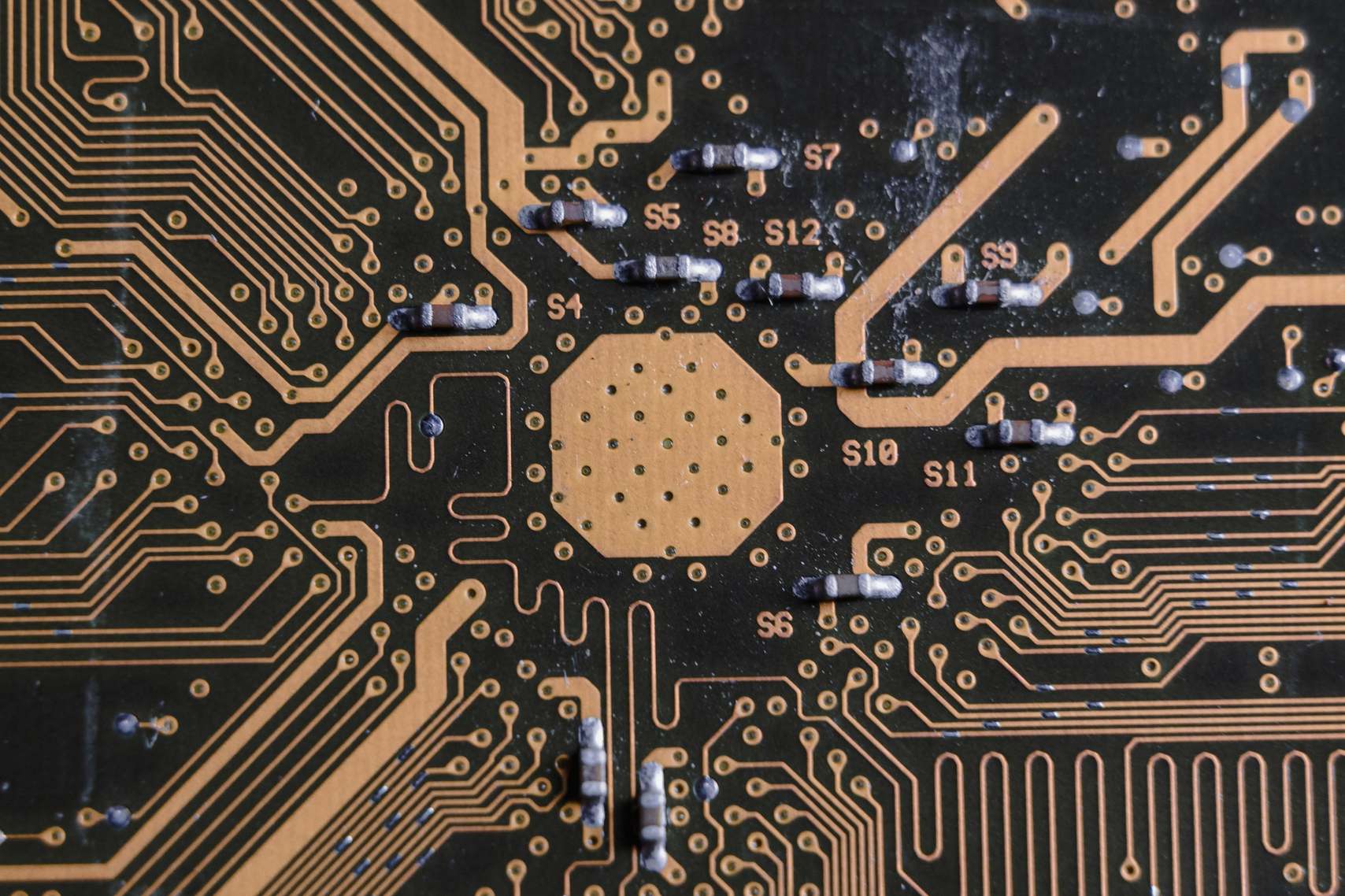 Close view of a printed circuit board surface with electronic pathways